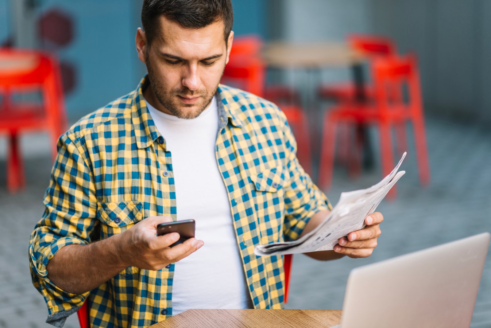 Uploaded imageman-posing-with-phone-newspaper.jpg